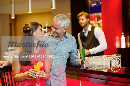 Couple enjoying drinks at the bar counter