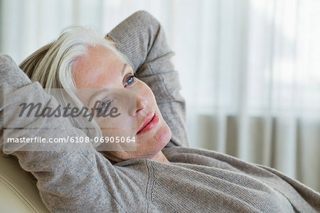 Woman reclining on a chair and thinking