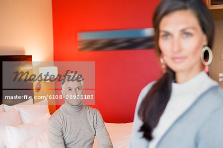 Man looking at his wife in a hotel room