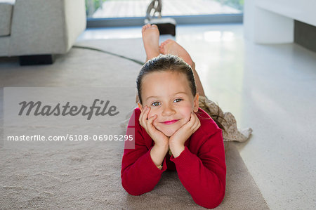 Girl lying on a carpet at home