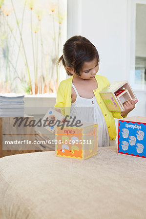 Girl playing with nested cubes