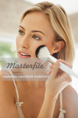 Woman applying make-up with a brush