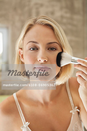 Woman applying make-up with a brush