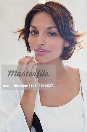 Woman applying cosmetics on her face