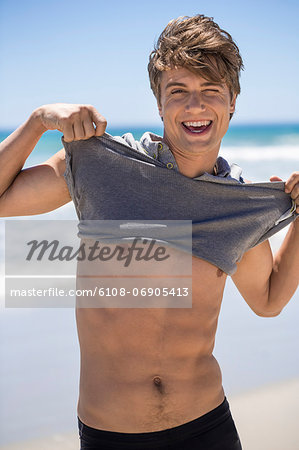 Smiling man showing his muscles