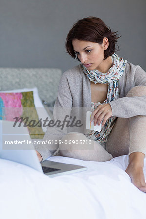 Woman working on a laptop and looking upset