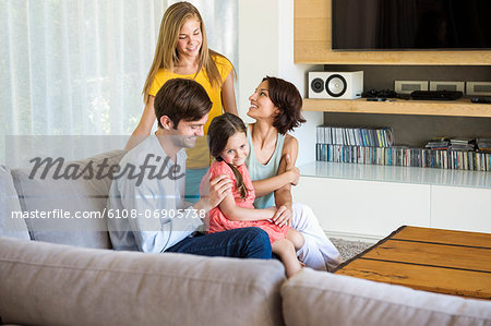 Parents with their children sitting in a living room