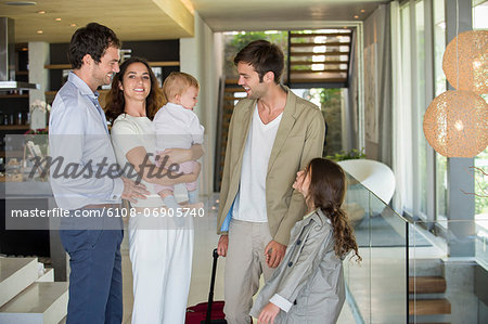 Man with his daughter arriving from holiday at his friends home Man with his daughter arriving from holiday at his friends home