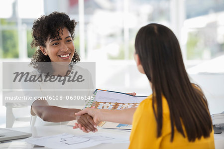 Real estate agent shaking hands with a woman