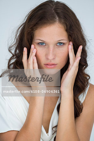 Woman checking wrinkles on her face