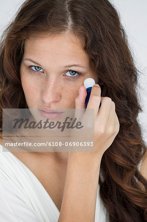 Woman applying anti wrinkle cream on her face