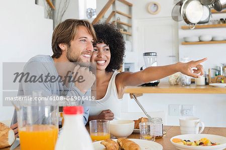 Smiling couple sitting at a dining table