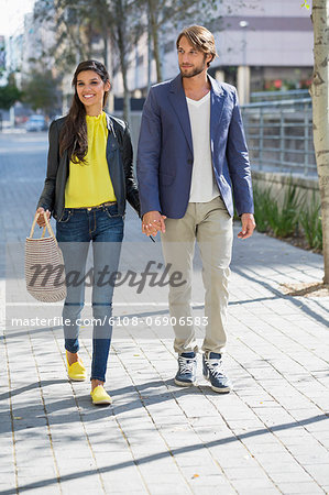 Happy couple walking on a street