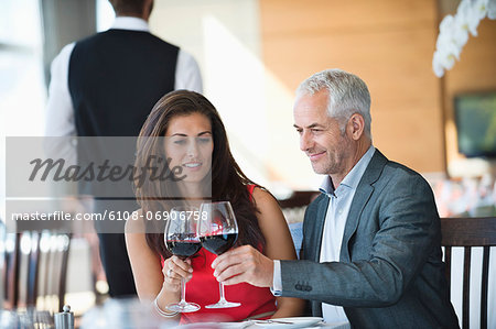 Couple toasting with wine glasses in a restaurant