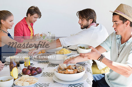 Friends eating lunch at dining table Friends eating lunch at dining table