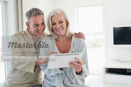 Smiling senior couple using a digital tablet