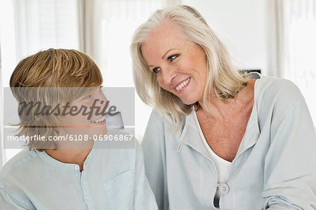 Woman and her grandson smiling at each other