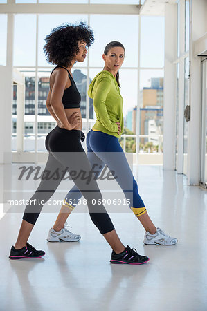 Woman exercising with her instructor in a gym