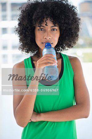 Portrait of a woman drinking water from a bottle