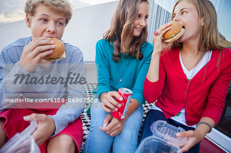 Friends enjoying fast food together Friends enjoying fast food together