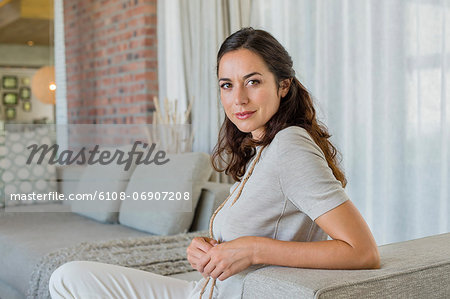 Portrait of a beautiful woman sitting on a couch