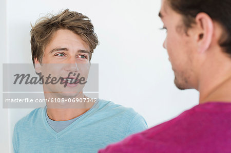 Two male friends talking to each other