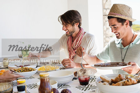 Friends eating lunch at dining table