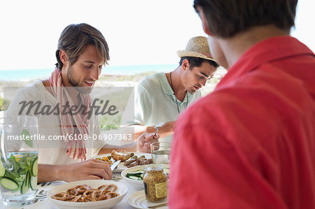 Friends eating lunch at dining table