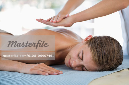 Woman receiving back massage from a massage therapist