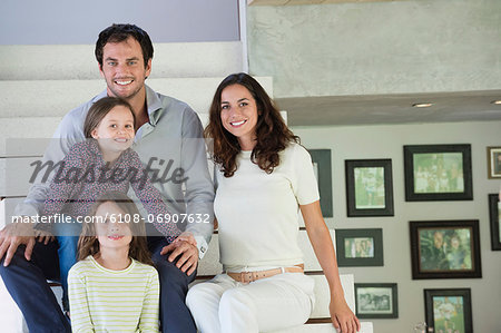 Family sitting on steps and smiling
