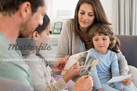 Parents showing photographs to their children