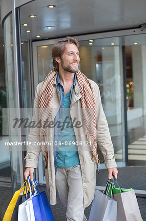 Man carrying shopping bags and smiling