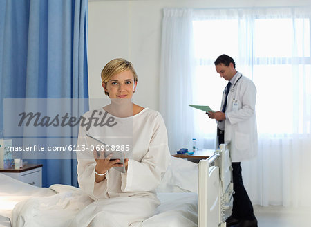 Patient using tablet computer in hospital room