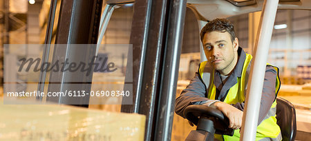 Worker operating machinery in warehouse