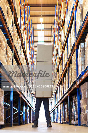 Worker holding boxes in warehouse