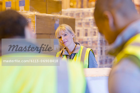 Workers talking in warehouse