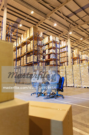 Business people talking in warehouse