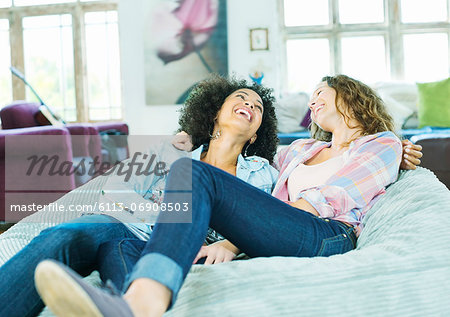 Women relaxing in beanbag chair together