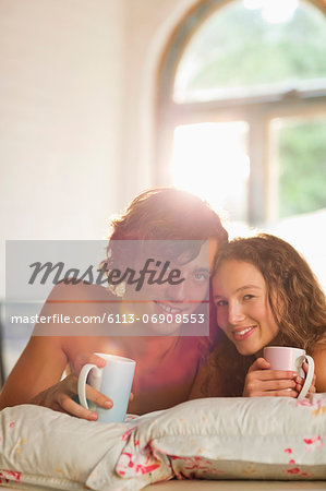 Couple having coffee together in bed