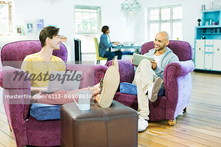 Men relaxing together in living room