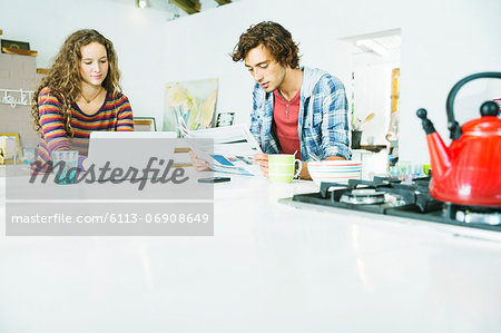 Couple relaxing together in kitchen