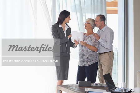 Financial advisor talking to couple in office