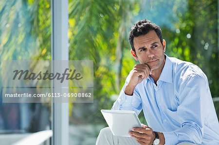 Businessman using tablet computer in office