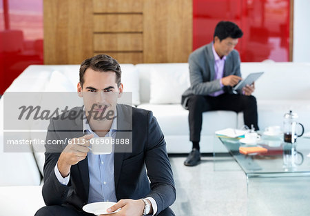 Businessman having cup of coffee in office