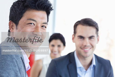 Businessmen smiling in office