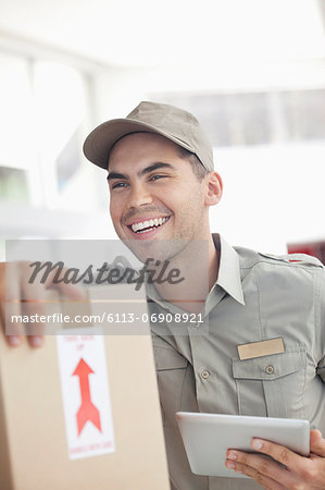Delivery boy using tablet computer