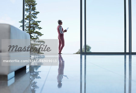 Reflection of businesswoman on office floor