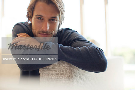 Man leaning on arm of sofa