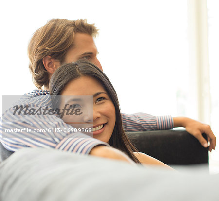 Smiling couple relaxing on sofa