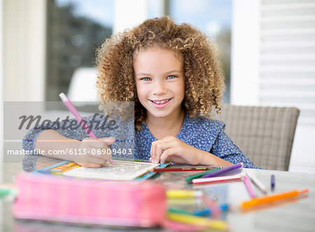 Girl coloring at table